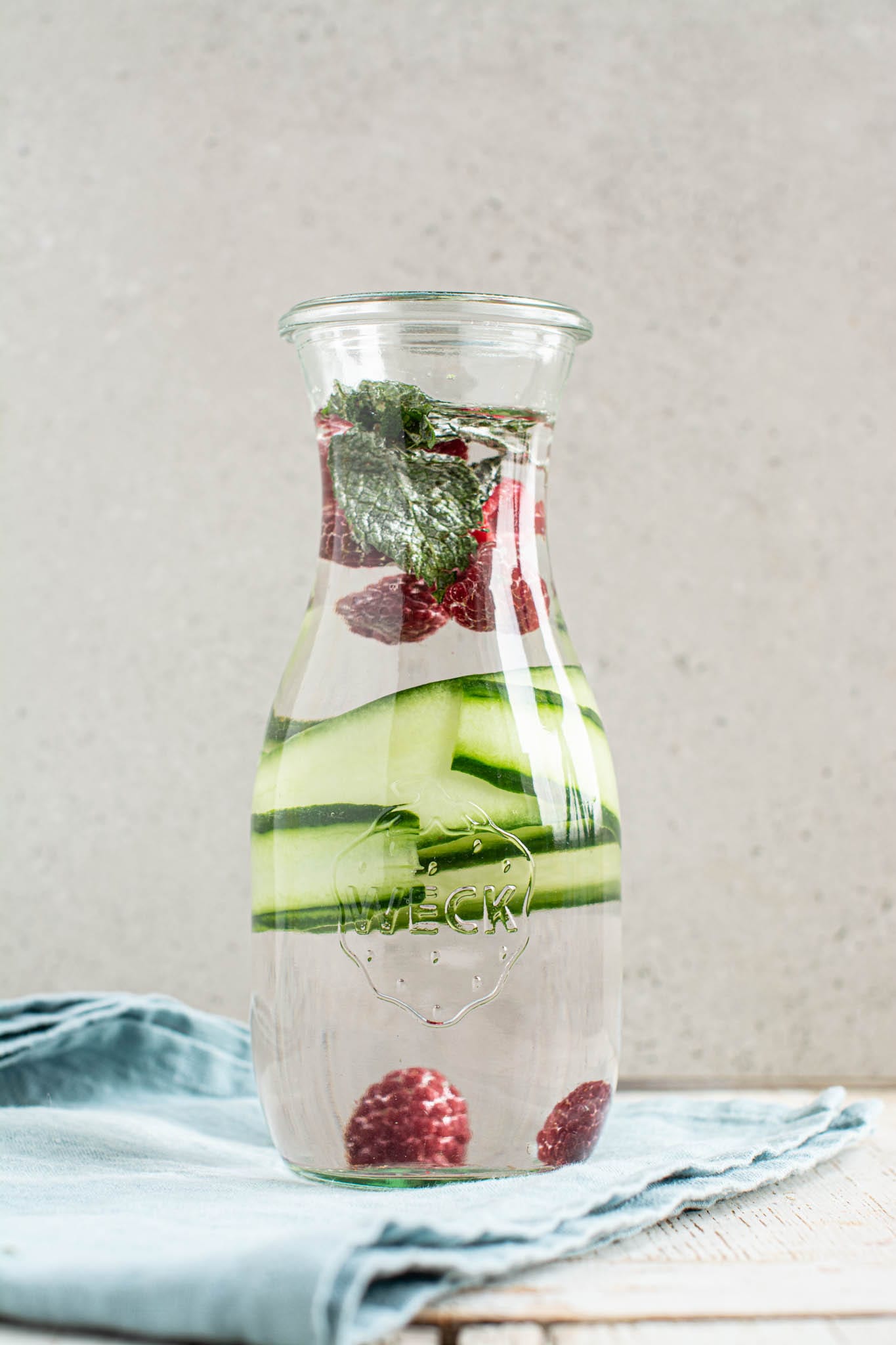 Fresh water infused with cucumber, raspberries and mint