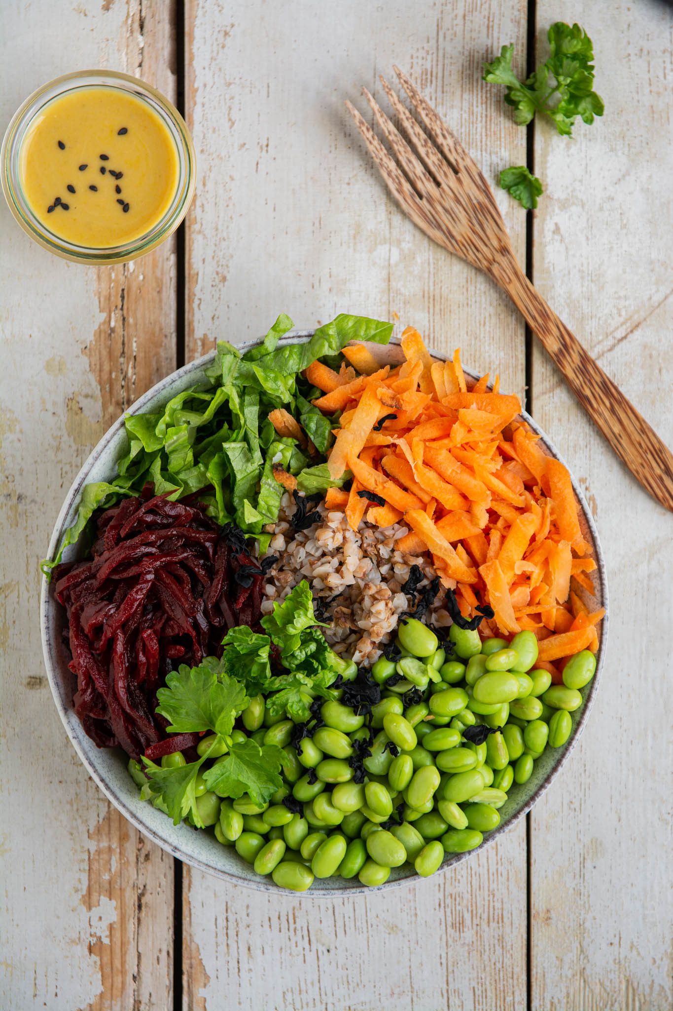 Learn how to make a filling balanced low glycemic vegan Buddha bowl with buckwheat, edamame beans, carrot, beetroot, and lettuce. And pour it over with a delicious oil-free salad dressing. 