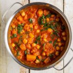 Learn how to make the heartiest and most comforting pumpkin curry with cauliflower and tomatoes. This quick and easy recipe is plant-based, oil-free, low-fat, and gluten-free.