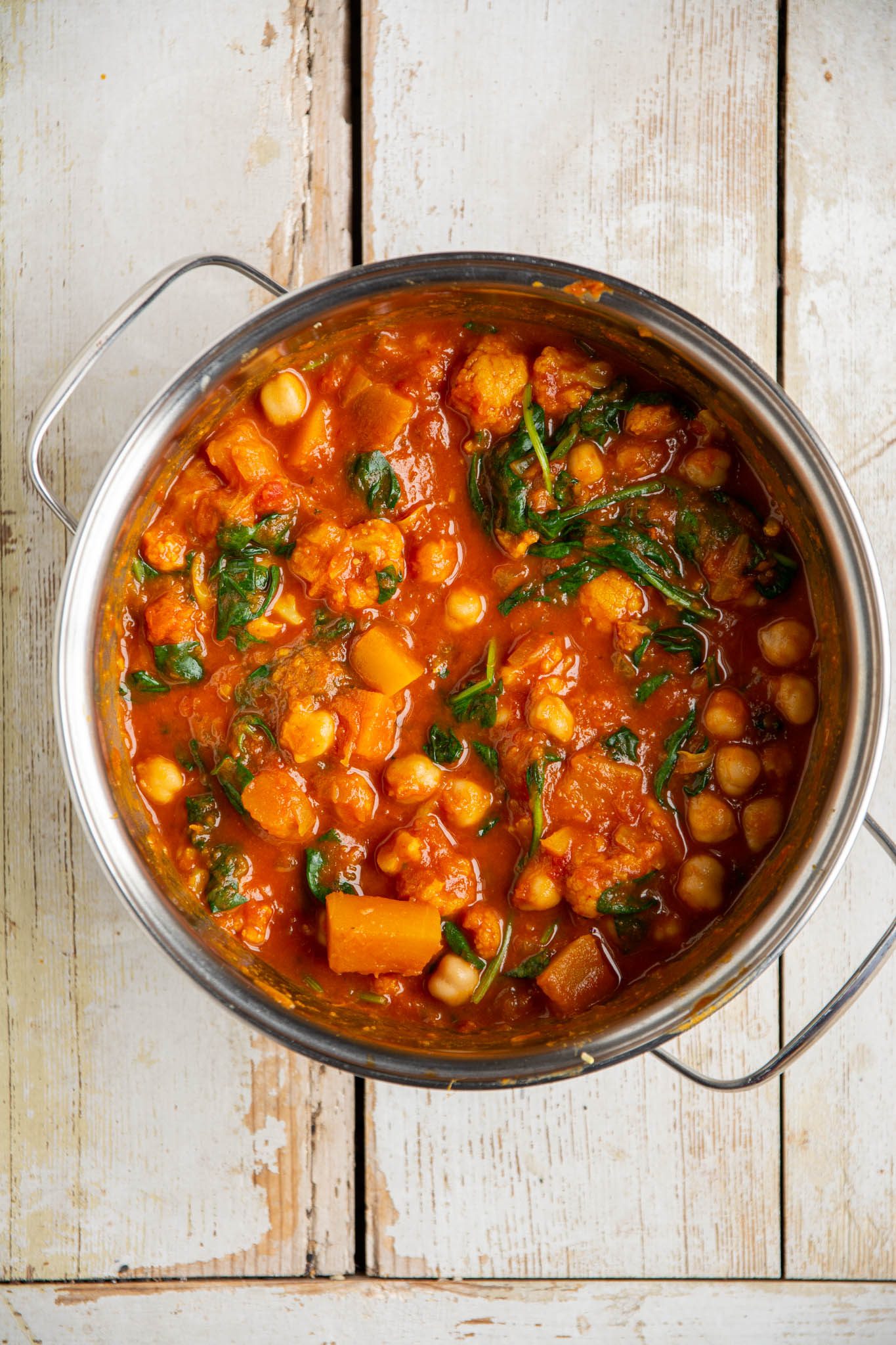 Learn how to make the heartiest and most comforting pumpkin curry with cauliflower and tomatoes. This quick and easy recipe is plant-based, oil-free, low-fat, and gluten-free.