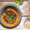 Learn how to make delicious and hearty festive vegan stuffed pumpkin with lentils, quinoa, and mushrooms. Moreover, my creamy and herby cashew-miso dressing will make this dish extra luscious.