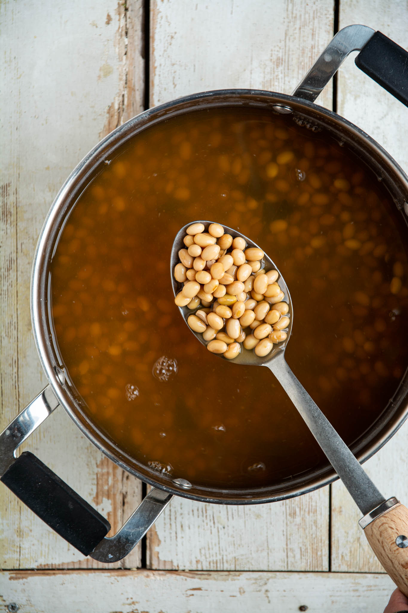 Learn how to cook soybeans at home in a regular pot or a saucepan. Use the cooked soybeans for high protein hummus, in soups, stews, and salads, or nibble on them as they are. 